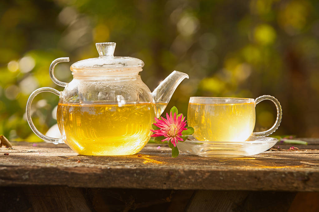 Delicious hot green tea in a beautiful glass bow