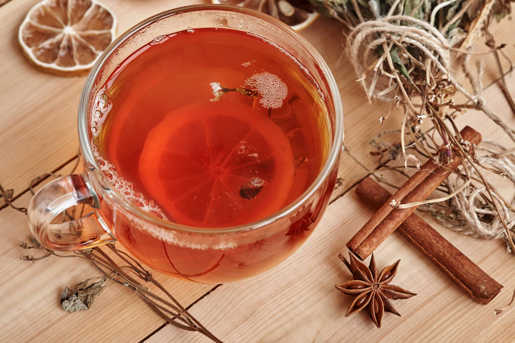 Glass cup with hot black tea