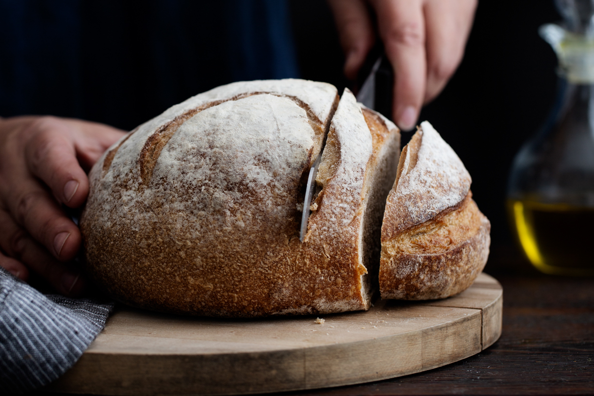 Slicing a round loaf of bread